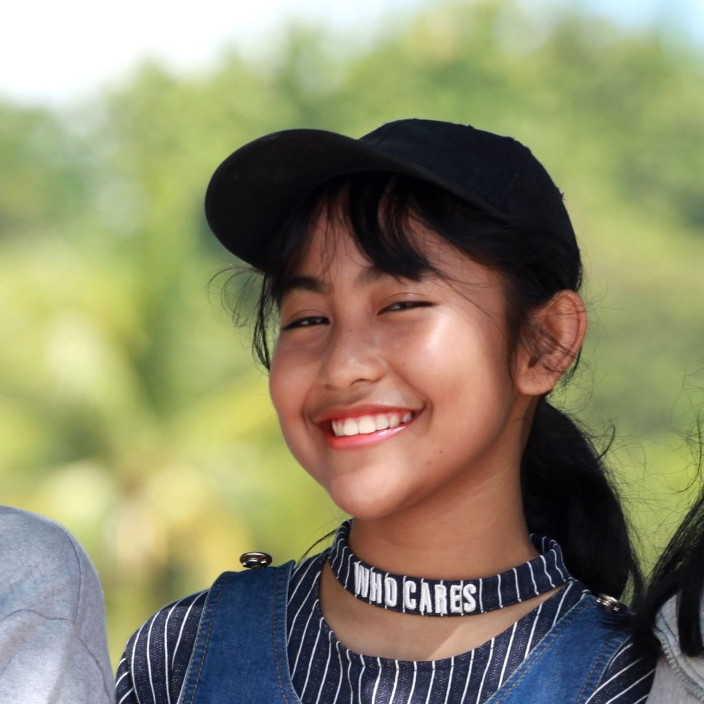 Sister with baseball hat and ponytail