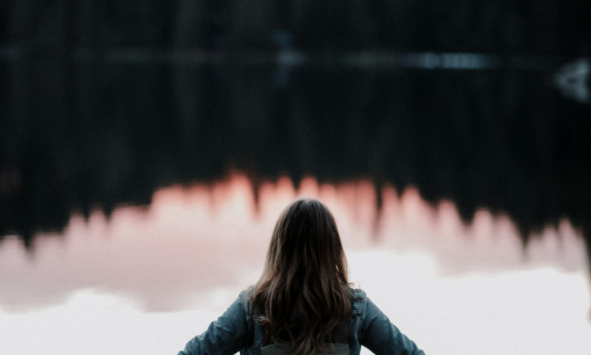 woman outstretched at lakeside